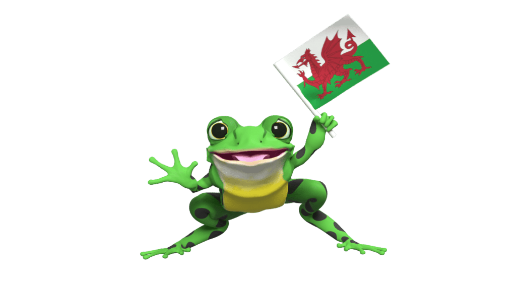Fred from Read Write Inc. waving a Welsh flag.